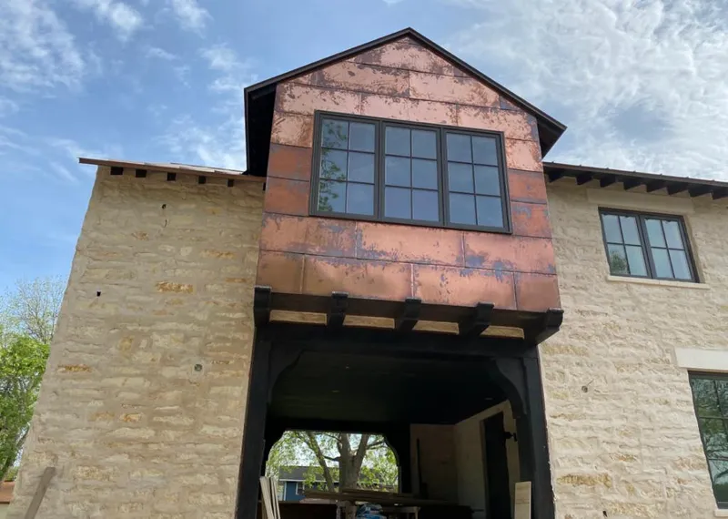 Copper metal panel facade on a stone building for Skylight Installation in Port Lavaca