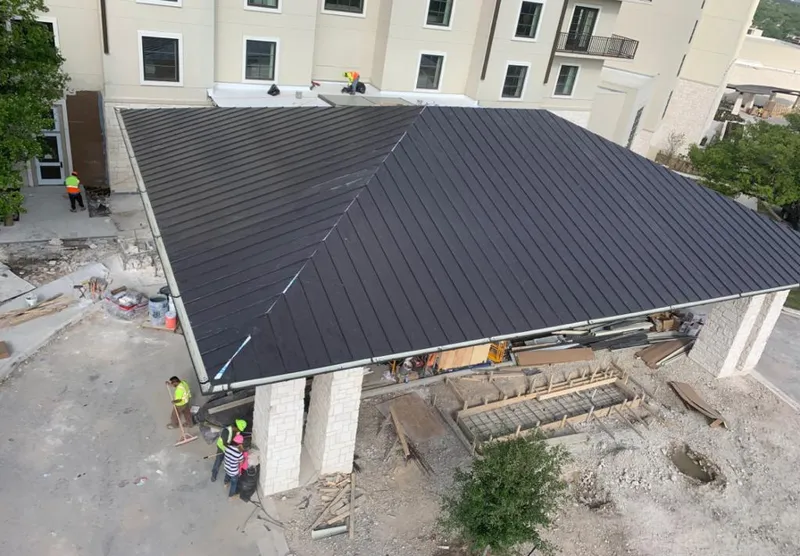 Metal roofing installation team working on a commercial building in Port Lavaca