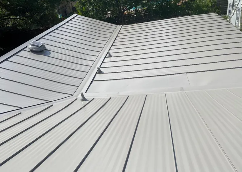 Solar attic fan installed on a metal roof for Roof Ventilation in Port Lavaca